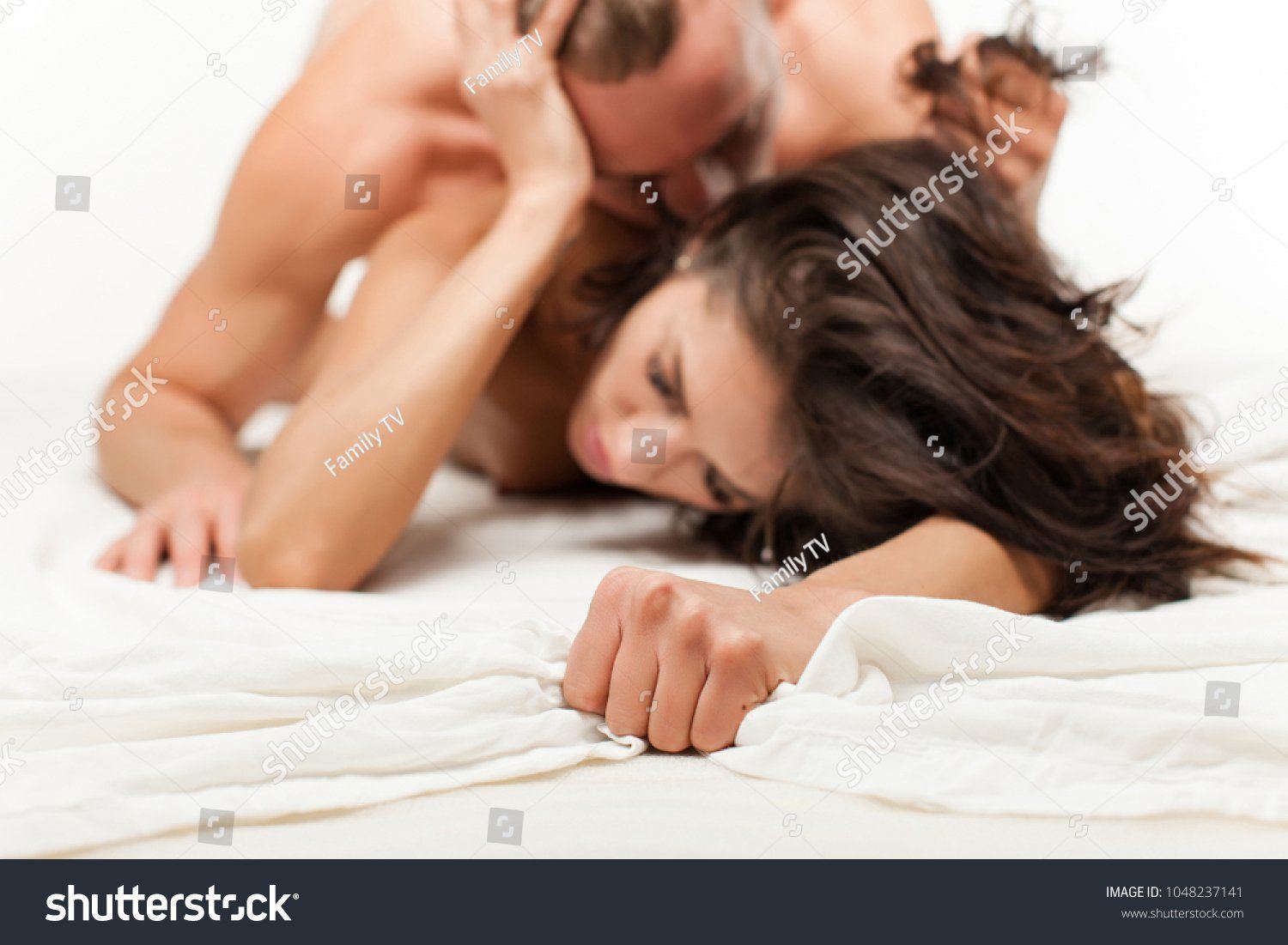 Nude boy and girl kissing passionately
