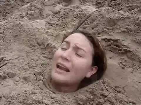 Nude girl buried on beach